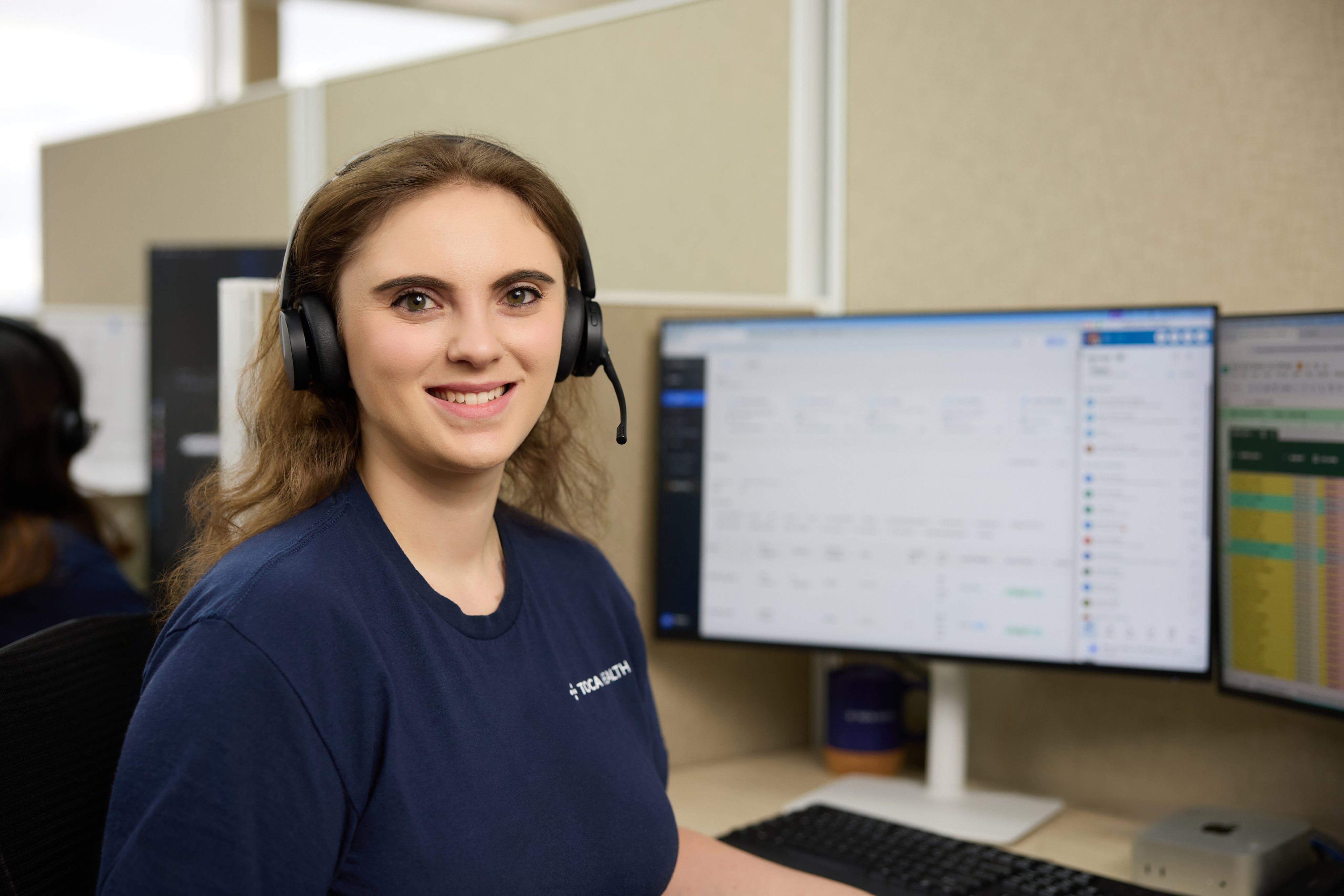 A TOCA care manager at her workstation with headset, using TOCA AI